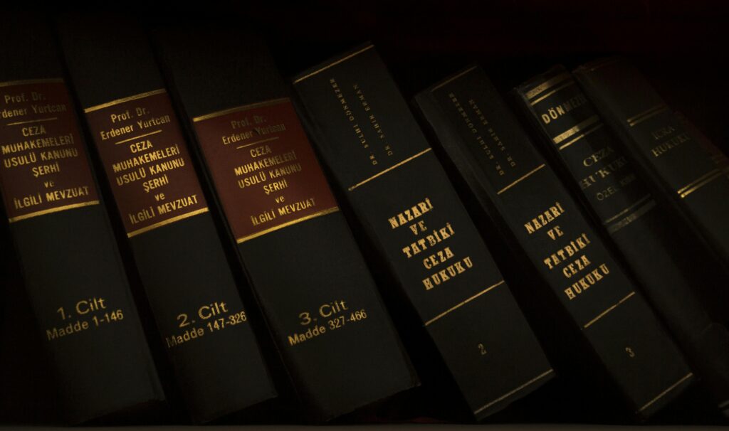 Stack of legal and literature books in a library showcasing various volumes.